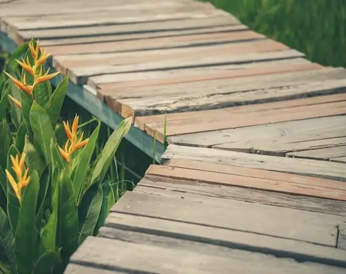 Construction of elevated timber boardwalk through garden landscape